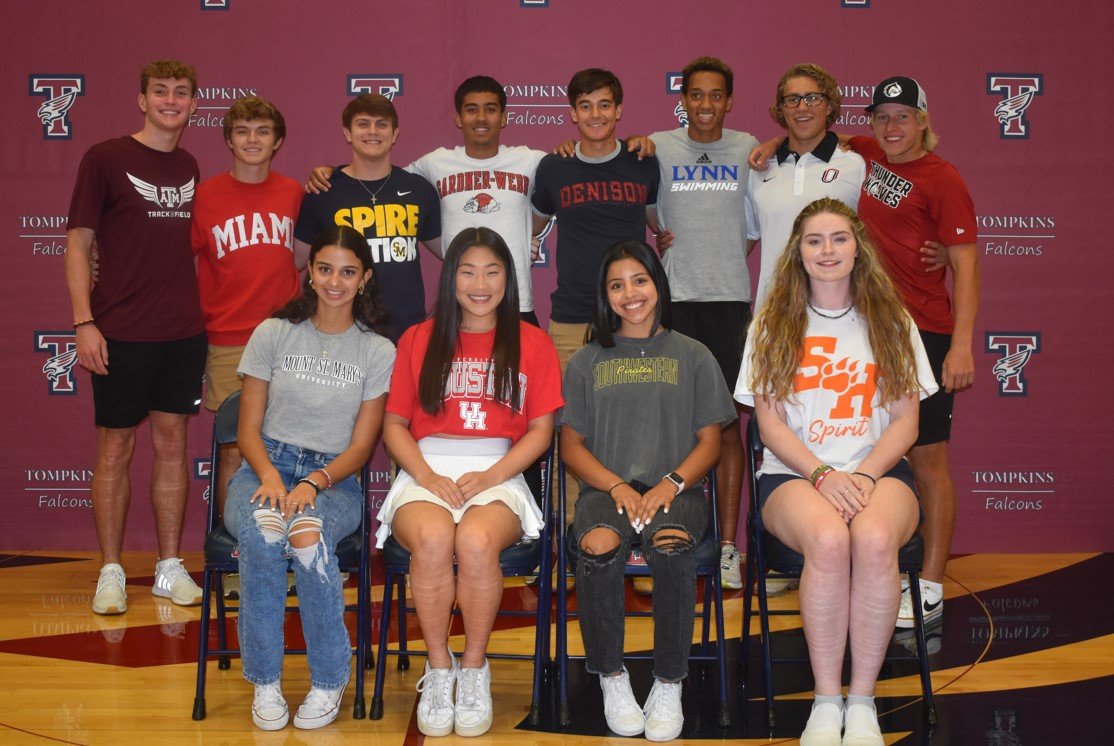 Tompkins athletes pose for a photo after signing to continue their athletic careers at the collegiate level.